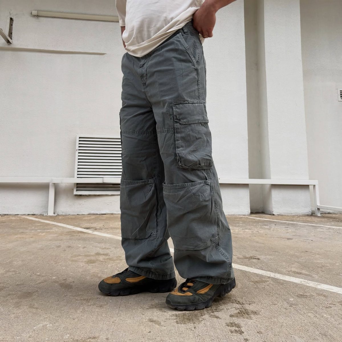 Person wearing baggy grey cargo pants and chunky black and tan boots.