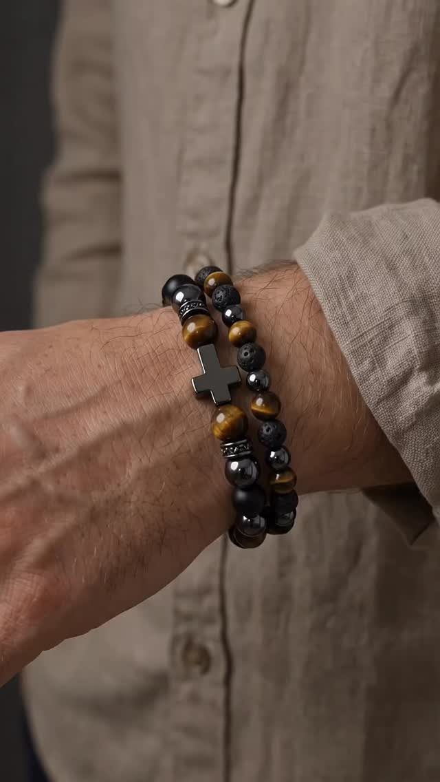 Tiger eye and black beaded bracelets with a cross charm on a man's wrist