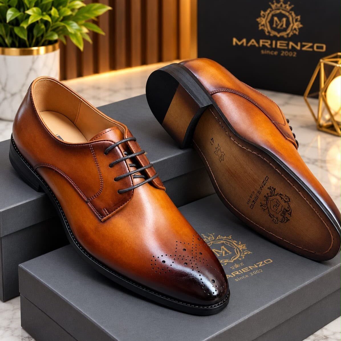 Brown leather men's oxford shoes resting on grey boxes with a brand logo.