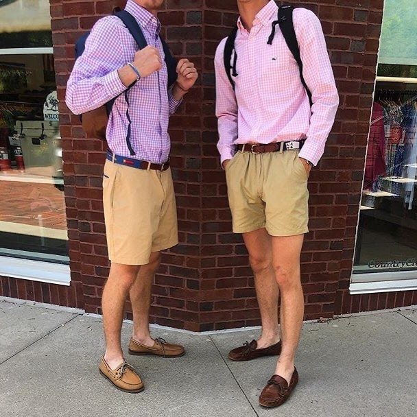 Two men wearing brown boat shoes, khaki shorts, and colorful gingham shirts.