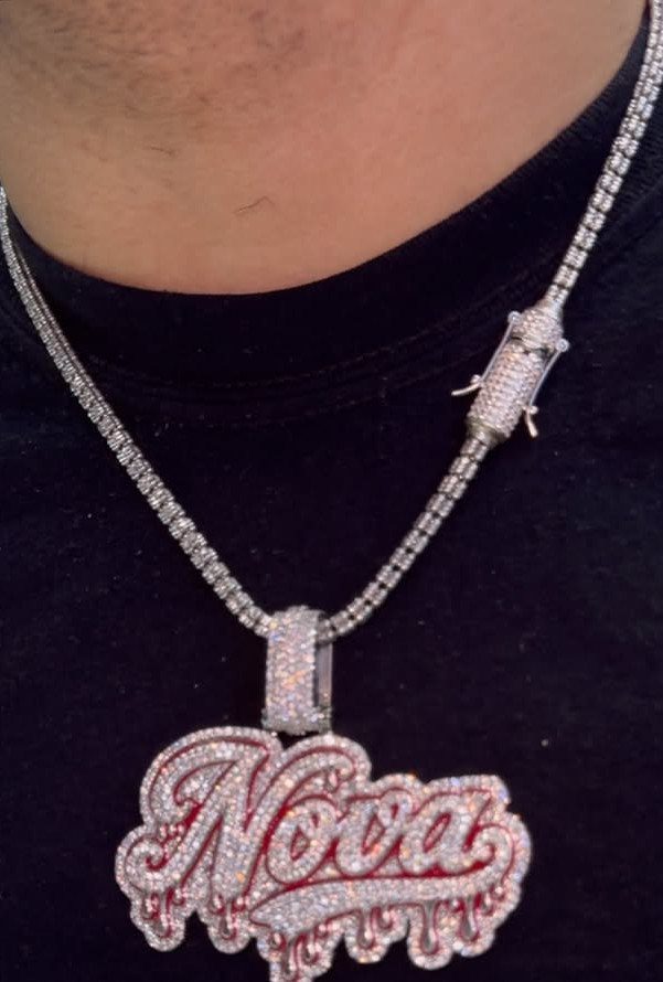 Silver diamond-encrusted chain necklace with a large personalized Nova name pendant.