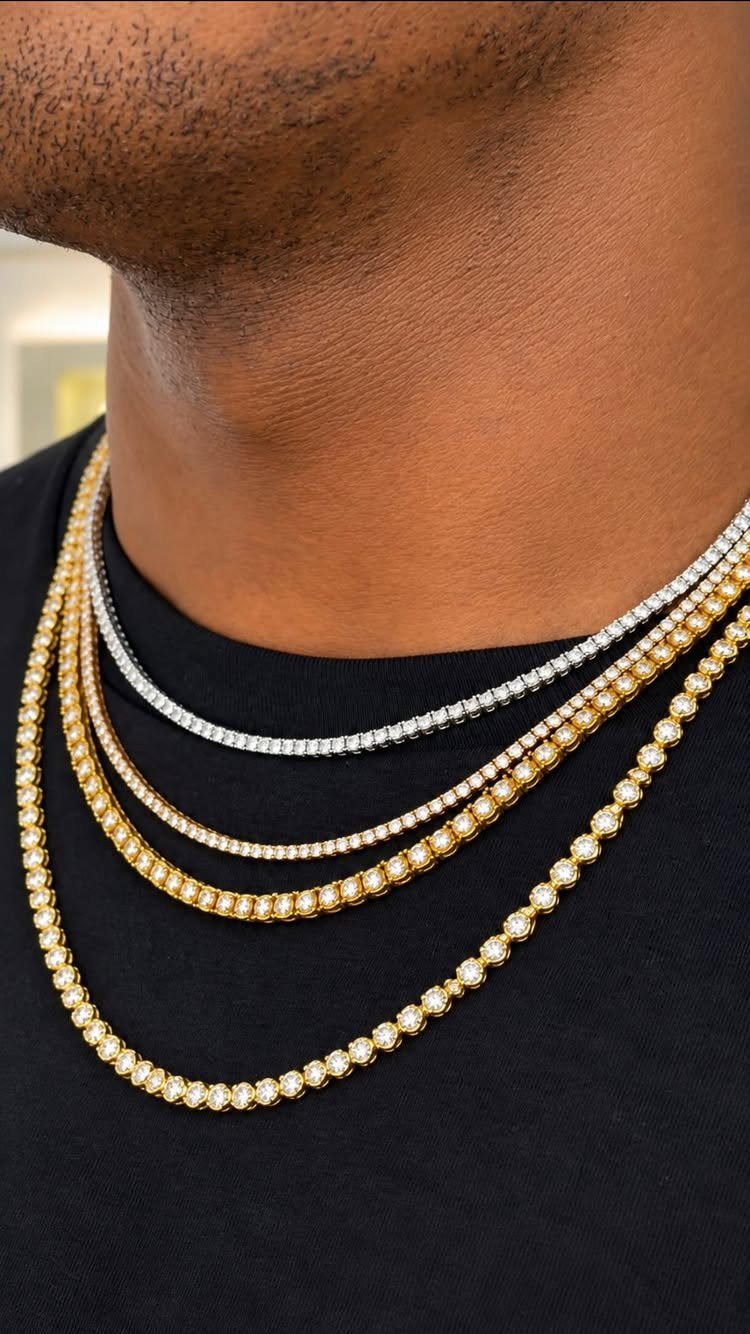 Four layered tennis necklaces in silver and gold worn by a man.