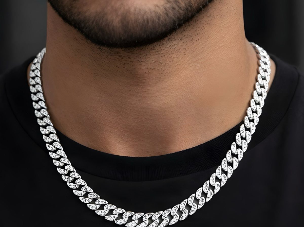 Silver Cuban link chain with diamonds worn by a man in a black shirt