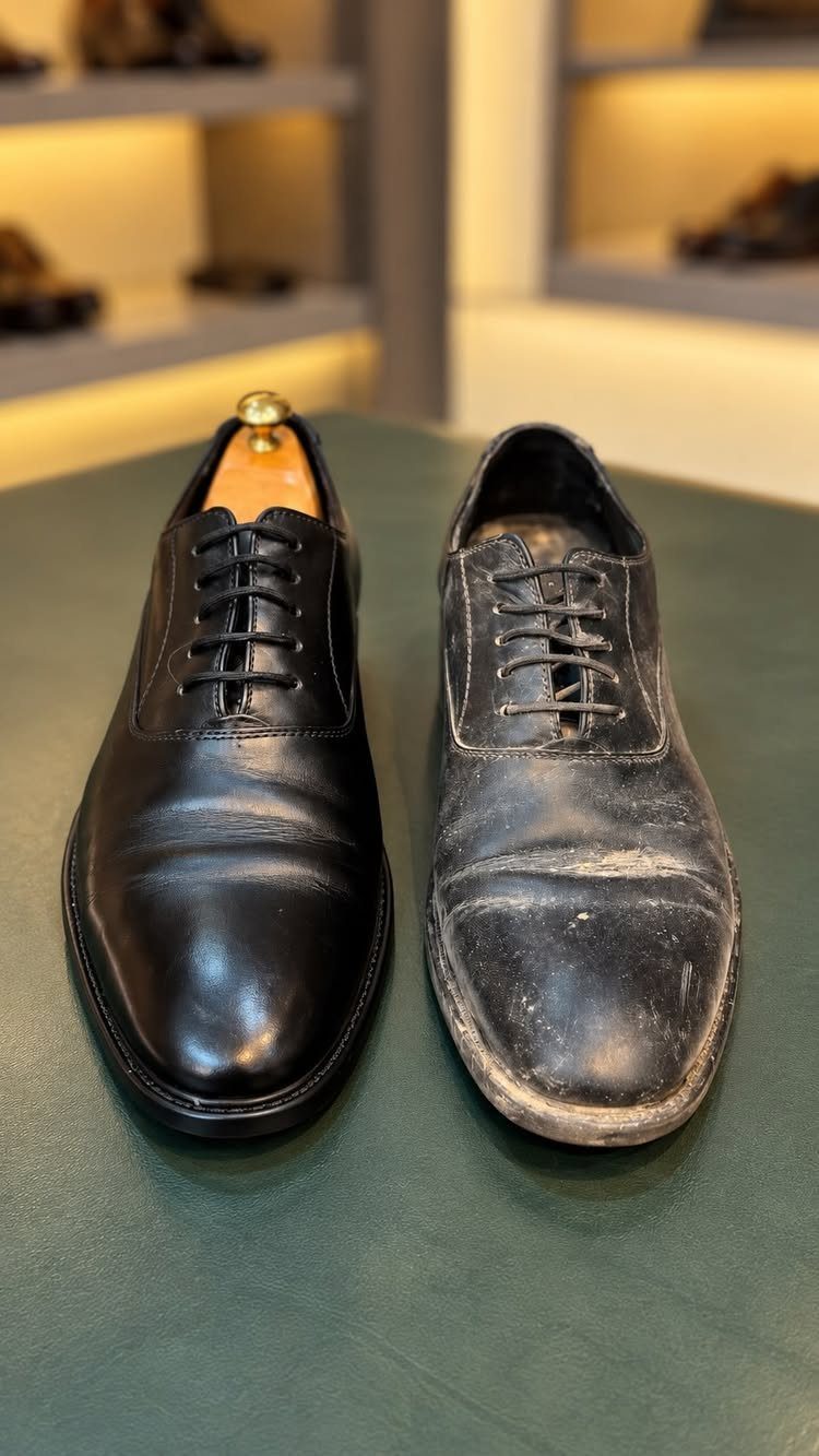 Polished and unpolished black leather oxford shoes side by side on green surface.