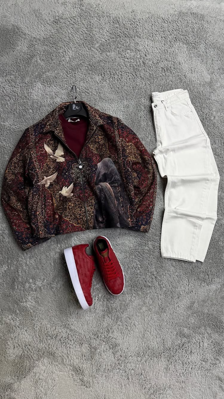 Red sneakers with white soles, white trousers, and a patterned red jacket.