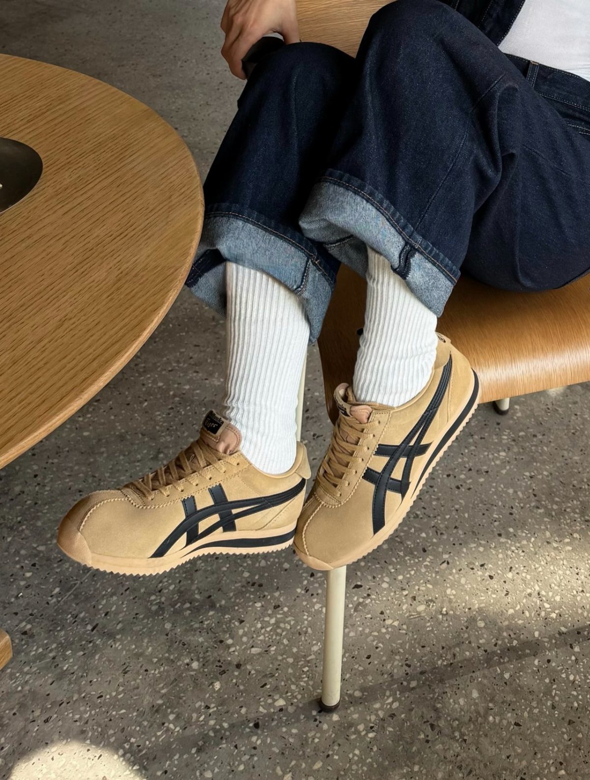 Tan suede Onitsuka Tiger Corsair sneakers with navy stripes and white ribbed socks.