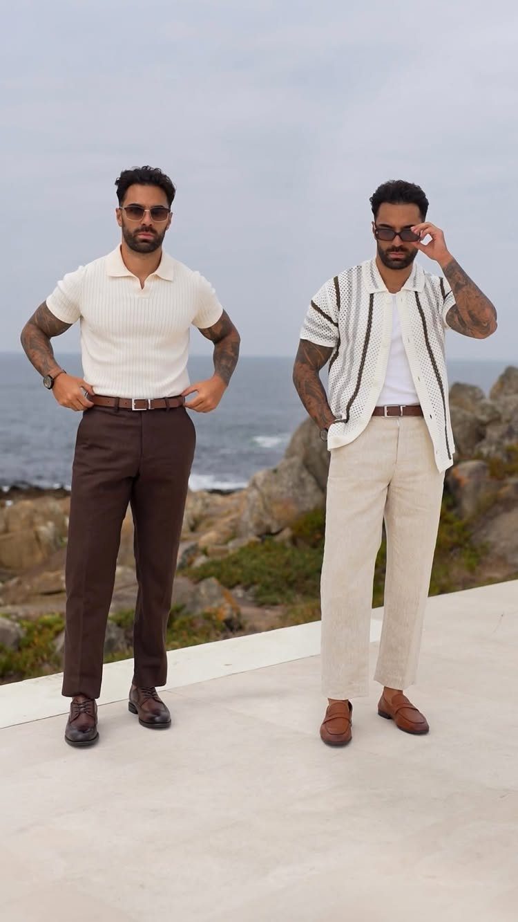 Two men posing in summer outfits with boat shoes on a coastal terrace.