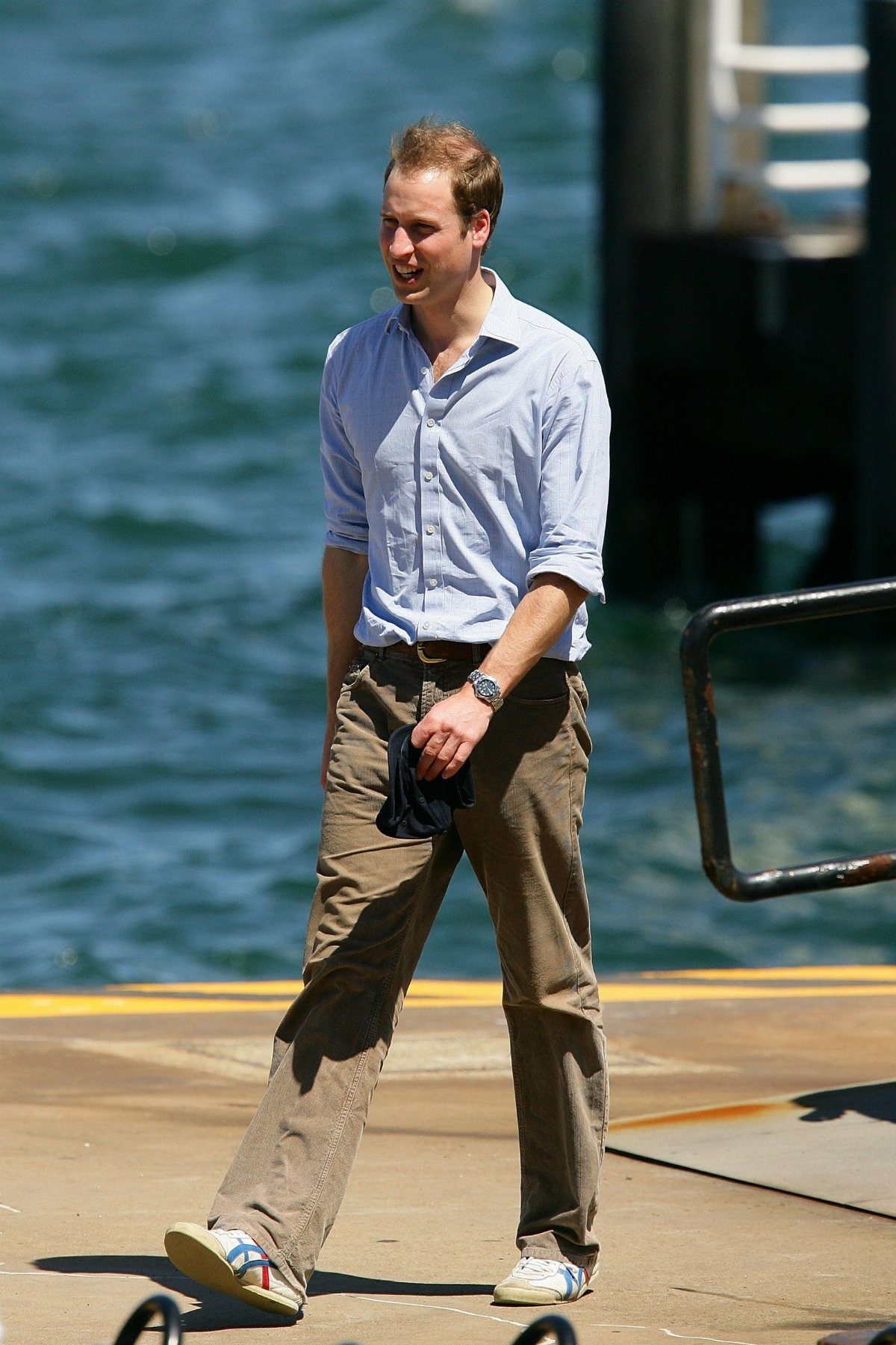 Man wearing a light blue shirt, khaki pants, and white Onitsuka Tiger sneakers.
